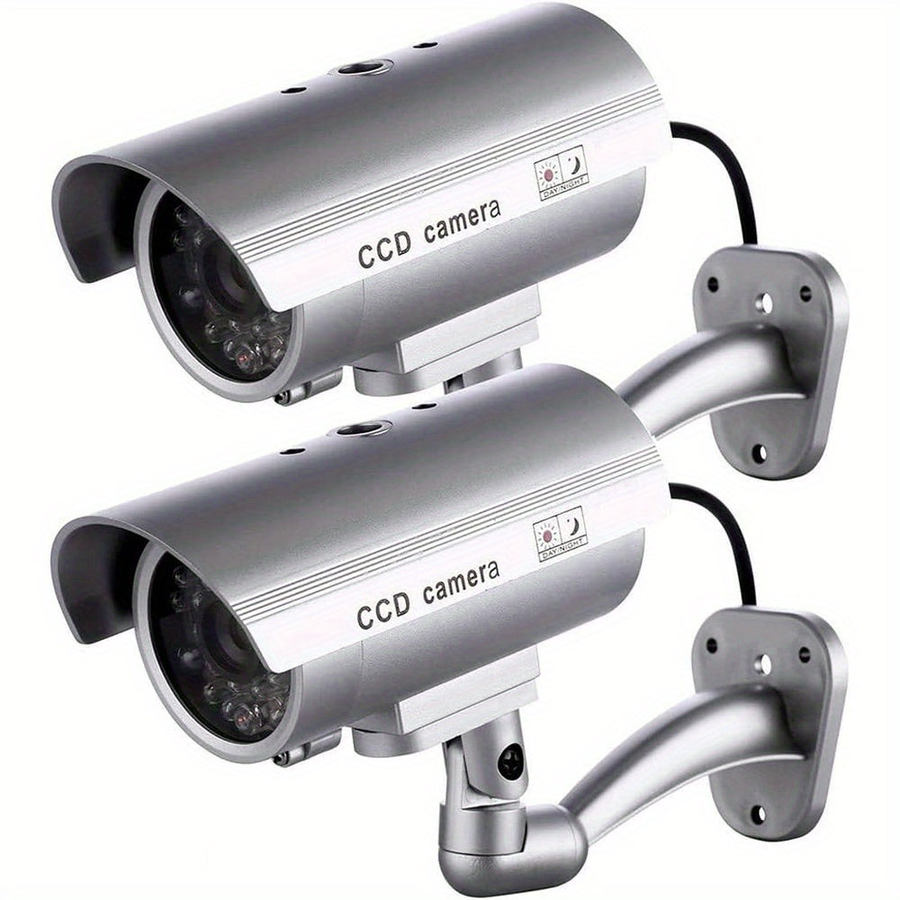 Caméra de surveillance factice – Système de vidéosurveillance simulée, lumières LED réalistes, support réglable et autocollants d'avertissement, caméra leurre de sécurité pour intérieur et extérieur – Lot de 2 ou 4