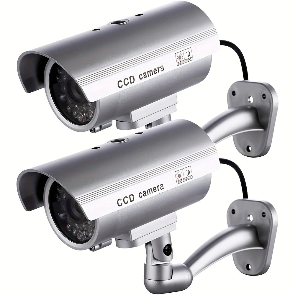 Caméra de surveillance factice – Système de vidéosurveillance simulée, lumières LED réalistes, support réglable et autocollants d'avertissement, caméra leurre de sécurité pour intérieur et extérieur – Lot de 2 ou 4