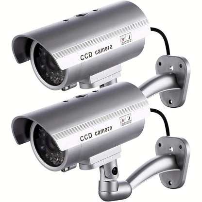 Caméra de surveillance factice – Système de vidéosurveillance simulée, lumières LED réalistes, support réglable et autocollants d'avertissement, caméra leurre de sécurité pour intérieur et extérieur – Lot de 2 ou 4